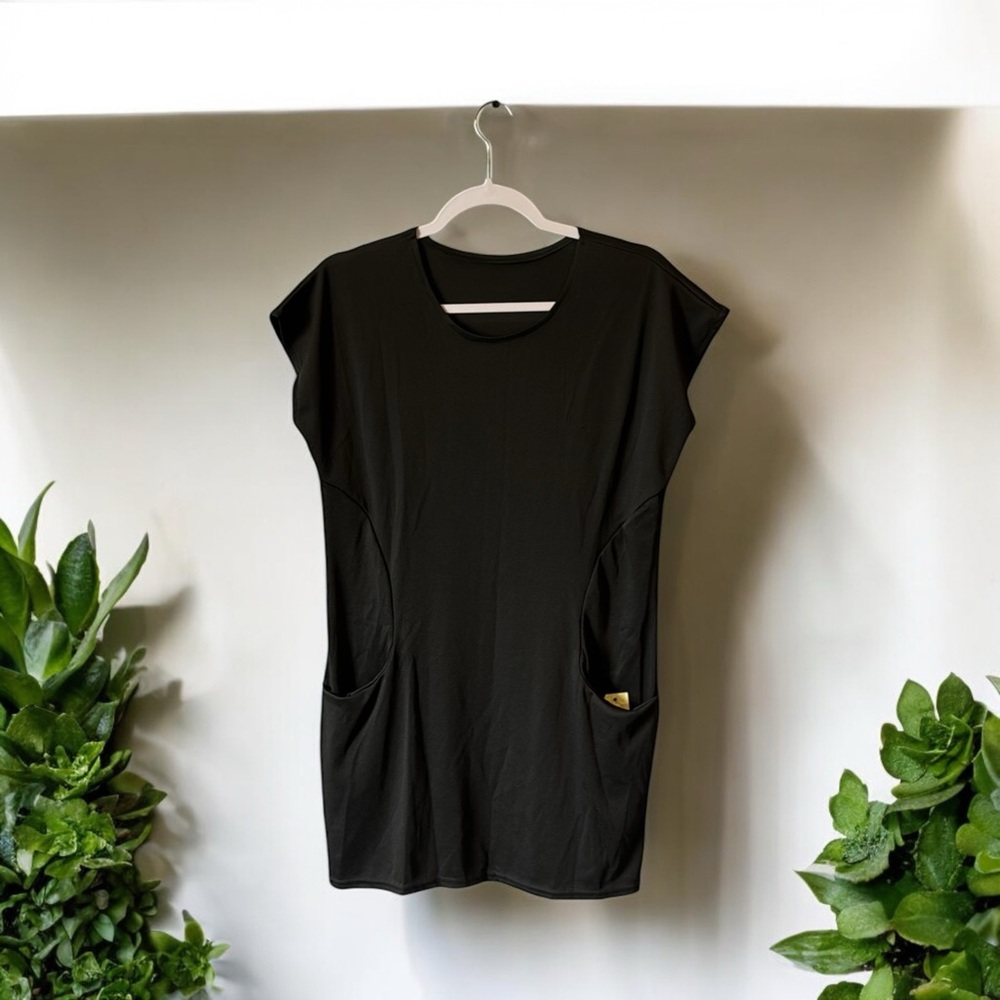 Black about knee length dress with two roomy front pockets short sleeves. Rk2n